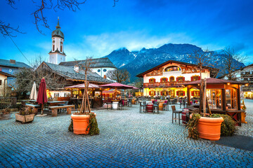 Alpine town of Garmisch Partenkirchen church and architecture evening view.