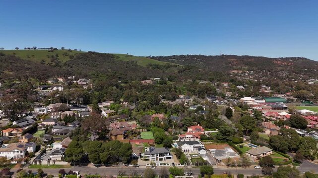 Springfield, South Australia: 4K aerial drone footage of Adelaide Hills suburb, green landscapes, residential houses, tree-covered hills and scenic countryside near Waite campus, Waite Arboretum