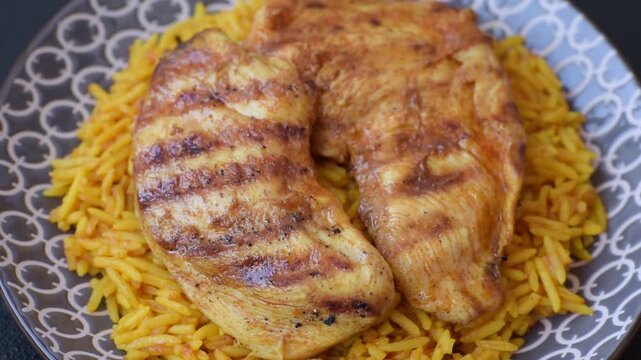 Kabsa or haneeth, an Arabic dish with rice and chicken, salt, and spices. Kabsa or haneeth as a food background for your design