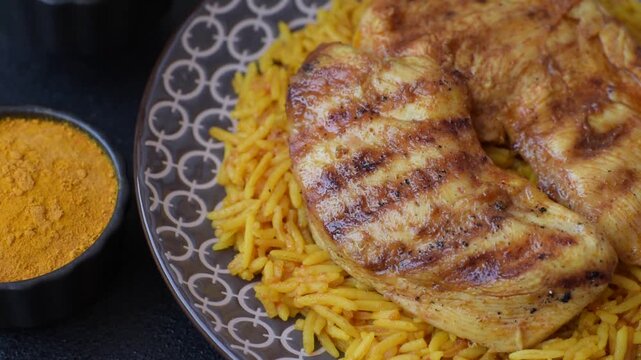 Kabsa or haneeth, an Arabic dish with rice and chicken, salt, and spices. Kabsa or haneeth as a food background for your design