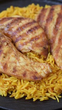 Kabsa or haneeth, an Arabic dish with rice and chicken, salt, and spices. Kabsa or haneeth as a food background for your design