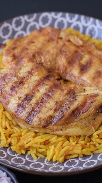 Kabsa or haneeth, an Arabic dish with rice and chicken, salt, and spices. Kabsa or haneeth as a food background for your design