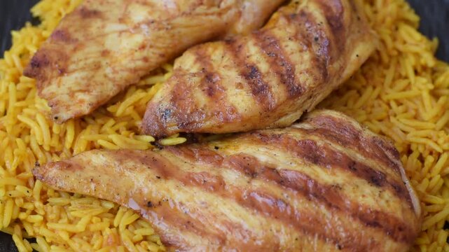 Kabsa or haneeth, an Arabic dish with rice and chicken, salt, and spices. Kabsa or haneeth as a food background for your design