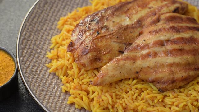 Kabsa or haneeth, an Arabic dish with rice and chicken, salt, and spices. Kabsa or haneeth as a food background for your design