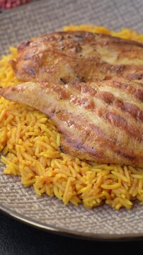 Kabsa or haneeth, an Arabic dish with rice and chicken, salt, and spices. Kabsa or haneeth as a food background for your design