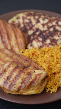 Dajaj Mashwi, an Arabic dish with rice and chicken, salt, and spices. Dajaj Mashwi as a food background for your design