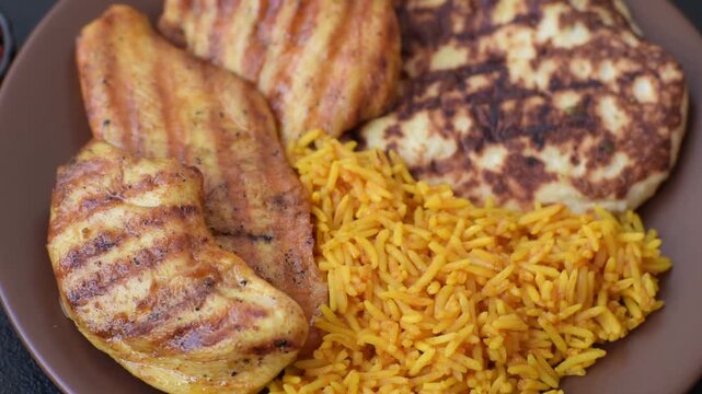 Dajaj Mashwi, an Arabic dish with rice and chicken, salt, and spices. Dajaj Mashwi as a food background for your design