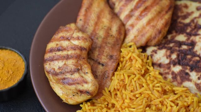 Kabsa or haneeth, an Arabic dish with rice and chicken, salt, and spices. Kabsa or haneeth as a food background for your design
