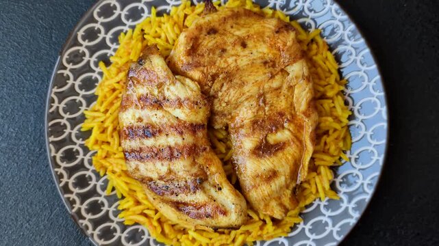 Kabsa or haneeth, an Arabic dish with rice and chicken, salt, and spices. Kabsa or haneeth as a food background for your design