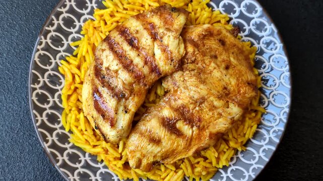 Kabsa or haneeth, an Arabic dish with rice and chicken, salt, and spices. Kabsa or haneeth as a food background for your design