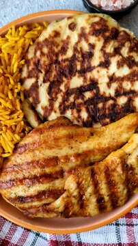 Dajaj Mashwi, an Arabic dish with rice and chicken, salt, and spices. Dajaj Mashwi as a food background for your design