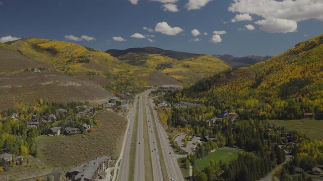 An aerial flyover near Vail, CO with fall colors of Aspen trees and interstate 70