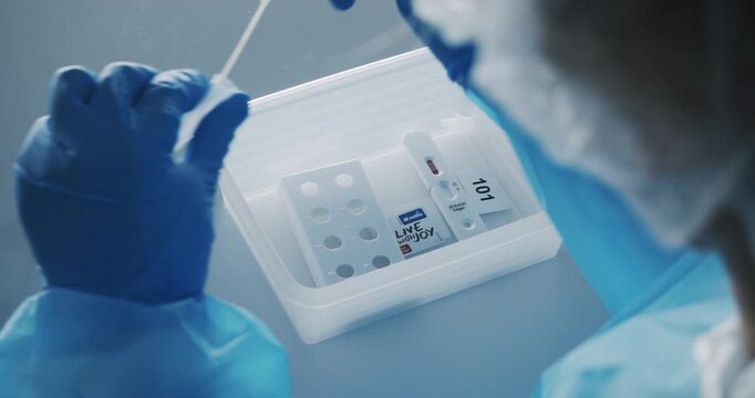 Medical worker processing nasal swab in COVID-19 lab Berlin 2020