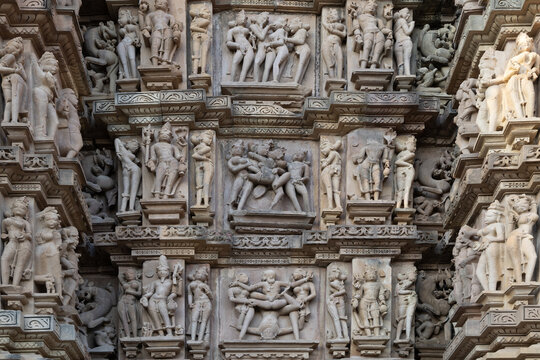View of intricate carvings of divine figures and celestial beings adorn the ancient temple walls, showcasing the rich artistry, Khajuraho, Madhya Pradesh, India.