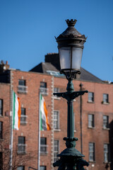 Fototapeta premium Vintage street lantern against Irish flag and brick facade