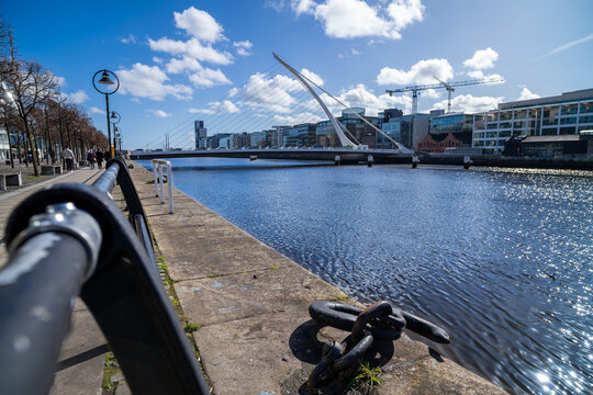 Quayside path follows River Liffey toward Samuel Beckett Bridge and Dublin docklands