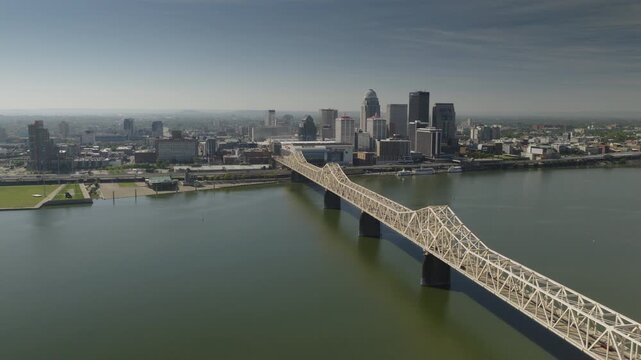 An aerial flyover of the Ohio river and bridges approaching Louisville, KY