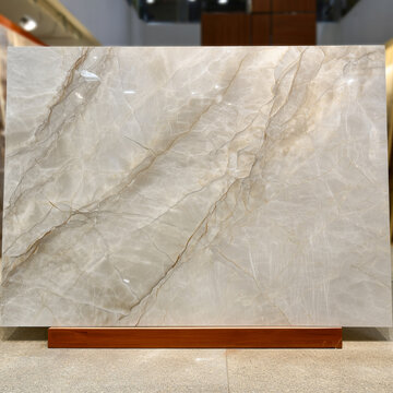 Large slab of elegant Taj Mahal quartzite or onyx stone with natural beige and brown veins. Luxury marble texture for interior design, countertops, and luxury floor tiling