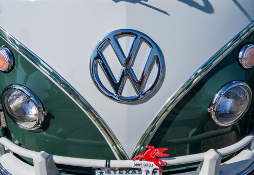 Georgetown, TX - 28 February 2026: Front View of a Classic 1965 Volkswagen Split Screen Microbus in Green and White with Chrome Logo