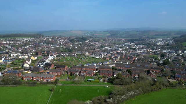 Crediton, Devon, England: DRONE VIEWS: The drone circles the town of Crediton showing suburban houses. Crediton is located on the main road and rail links between Exeter and Barnstaple. 