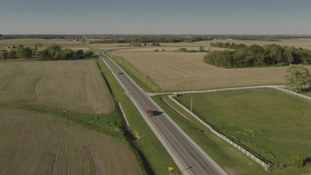 An Aerial flyover vehicles on a rural road near farmland, Tower Hill, IL