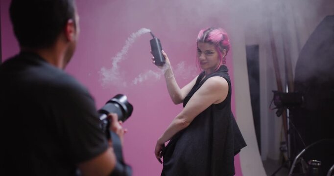 Model poses with expressive movements in studio, showcasing creativity and style during a dynamic photoshoot