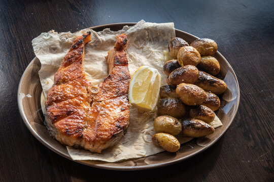 Grilled salmon with potatoes. Taken at a restaurant in Sochi, Russia.