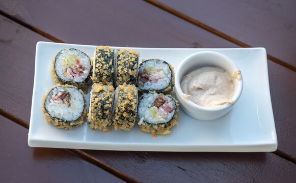 Rolls with salmon, eel, bacon and mozzarella cheese