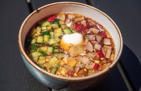Okroshka soup in Russia. Okroshka is a cold soup made of mostly raw vegetables, boiled potatoes, eggs, cooked meat such as beef, veal, sausages or ham and kvass