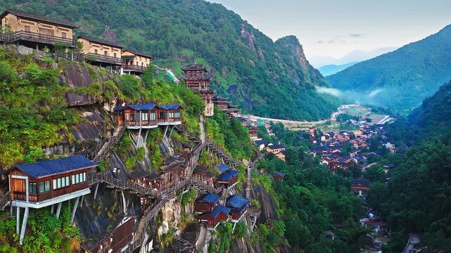 Traditional wooden houses and cliffside village built on steep mountain cliffs in Wangxian Valley, Shangrao, Jiangxi, China. Ancient-style architecture.