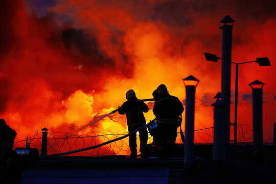 A team of firefighters is extinguishing a fire at an industrial building in the city