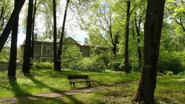 Lateral drone glide over grass in Klin park