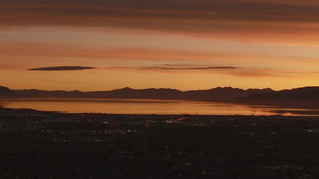An aerial shot of a dramatic sunset over Utah Lake and Valley, Pleasant Grove, UT