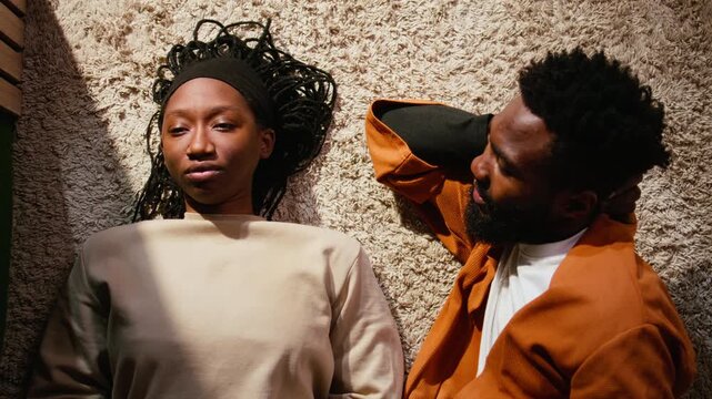 African american woman ignoring her boyfriend and giving up on the fight, man begging for a compromise and asking for a second chance. Uninterested indifferent girl offended by her partner.