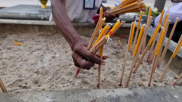 Sacred ritual performed through precise placement of incense and flowers