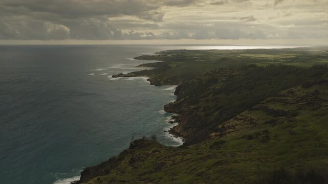 An aerial flyover of the coast of Kauai and dramatic clouds in late afternoon, Hawaii