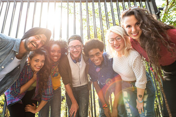 Diverse group smiling outdoors.