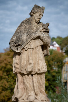 Historic sandstone statue of St. Nepomuk at the confluence of Urft and Olef rivers. Located at Platz am Nepomuk, Gem&uuml;nd, Eifel region