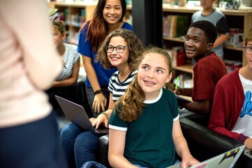 Obraz premium Diverse students collaborating with laptops