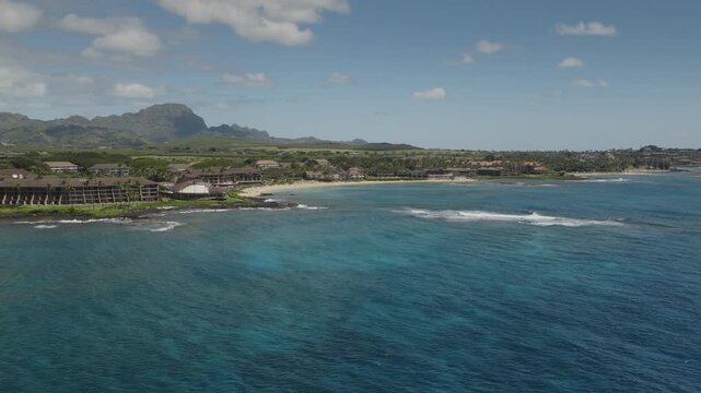 An aerial flyover of the south coast of Kauai near Poipu, Kauai, HI