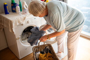Elderly woman doing laundry chores