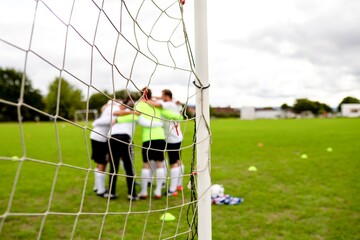Team huddle on soccer field. © Rawpixel.com