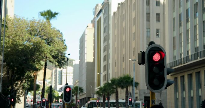 Foreground signal changing to green, starting cars, bus resuming flow on city avenue, copy space