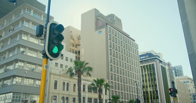 Fixed downtown camera is starting to record as traffic signal is showing green to control vehicles