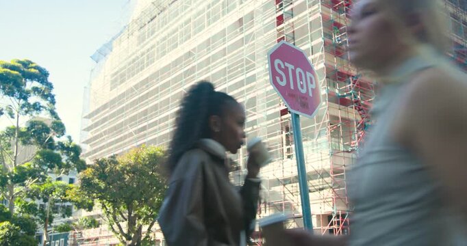 After pause stop sign marking corner scaffold in mesh woman walking holding coffee, commuting