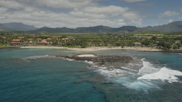 An aerial flyover of the south coast of Kauai near Poipu, Kauai, HI
