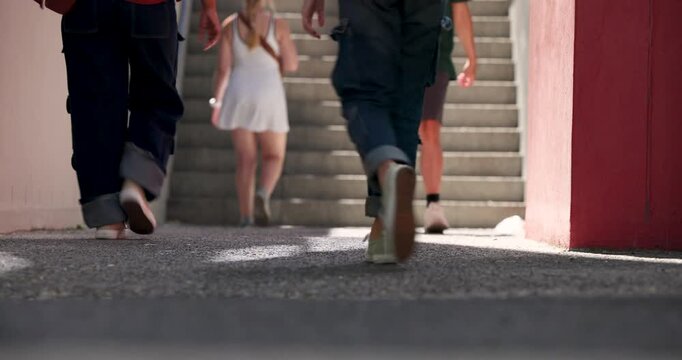 Diverse pedestrians stepping down steps, woman in ripped jeans carrying coffee, heading to street