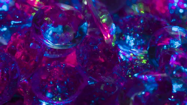 Fabulous Shine of Diamonds. Small crystals with a classic cut on a mirror surface slowly move in front of the camera, shimmering in the laser beams