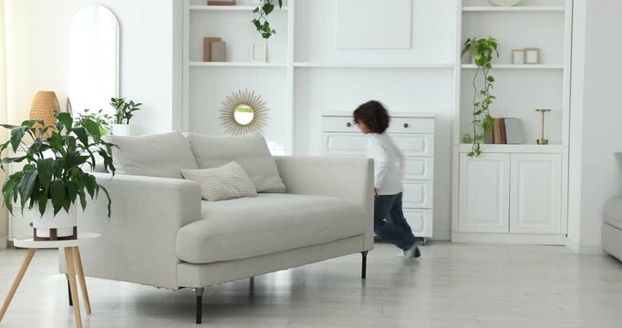 Cute little brothers playing chase and having fun at home