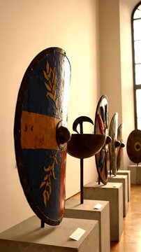Ancient shields on display in a museum gallery